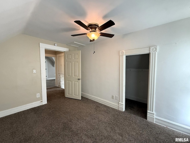 833 Willard St, Galesburg, IL 61401 - unfurnished bedroom with a spacious closet, dark carpet, lofted ceiling, and ceiling fan