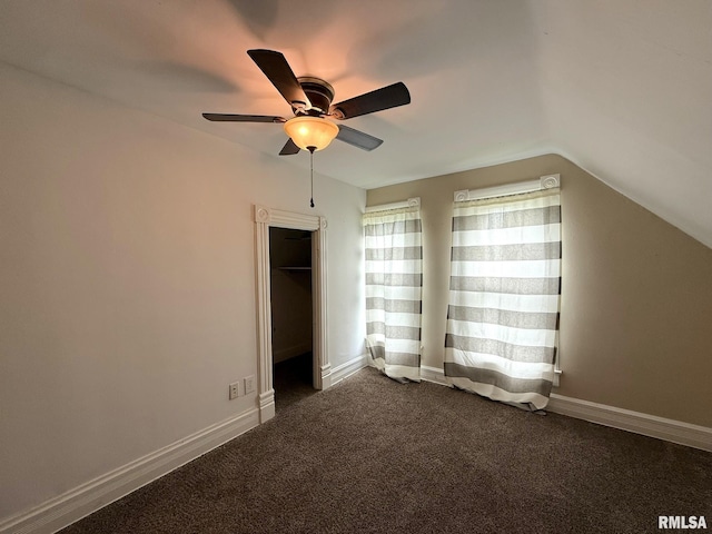 833 Willard St, Galesburg, IL 61401 - unfurnished bedroom with vaulted ceiling, dark colored carpet, and a ceiling fan