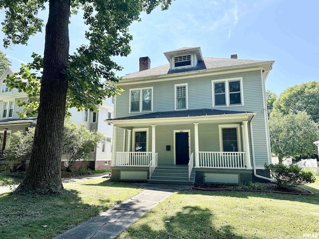 231 N Webster Ave, Jacksonville, IL 62650 - american foursquare style home featuring a chimney, a porch, and a front lawn