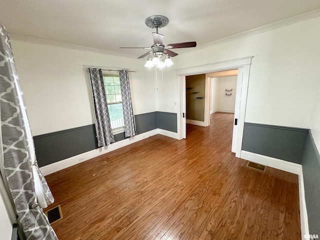 231 N Webster Ave, Jacksonville, IL 62650 - spare room featuring wood finished floors, ceiling fan, and crown molding