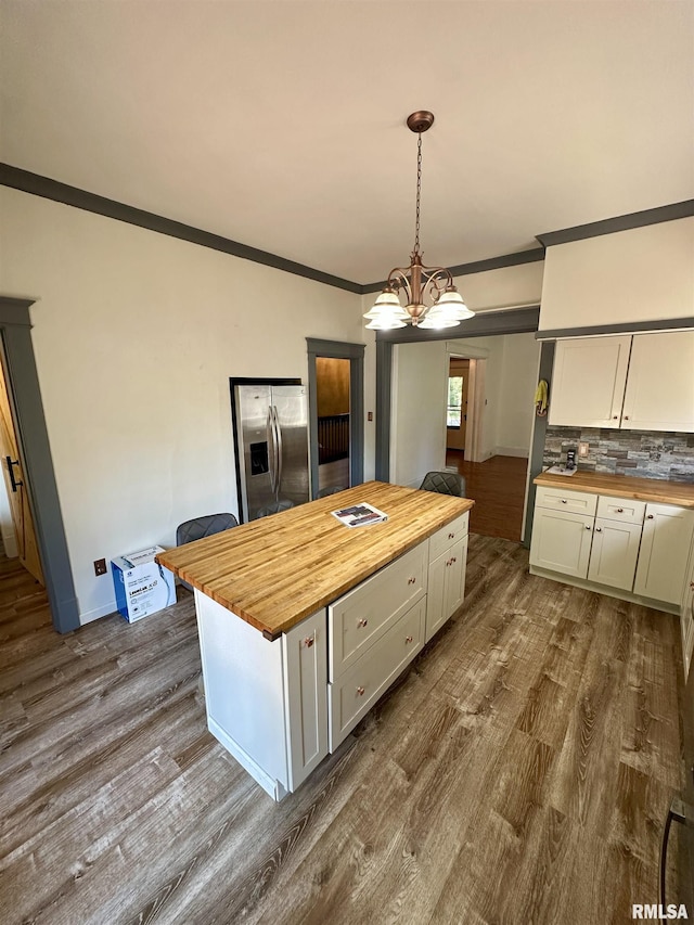 231 N Webster Ave, Jacksonville, IL 62650 - kitchen featuring wood counters, stainless steel refrigerator with ice dispenser, crown molding, dark wood-type flooring, and white cabinetry