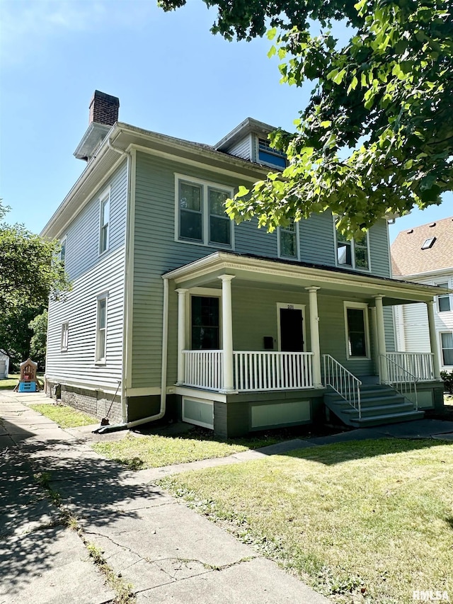 231 N Webster Ave, Jacksonville, IL 62650 - view of front facade featuring a chimney, a porch, and a front yard