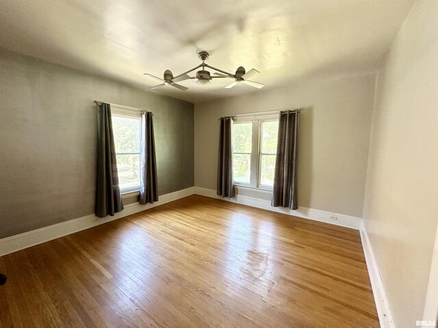 231 N Webster Ave, Jacksonville, IL 62650 - empty room featuring healthy amount of natural light, light wood-style flooring, and a ceiling fan