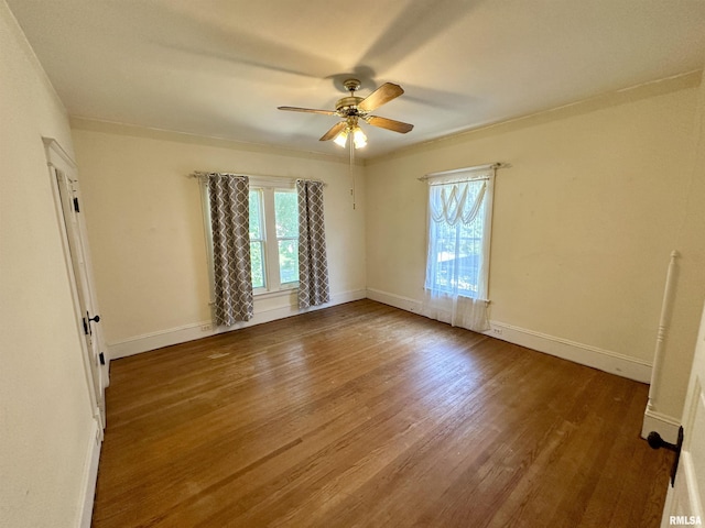 231 N Webster Ave, Jacksonville, IL 62650 - empty room with healthy amount of natural light, ceiling fan, and wood finished floors
