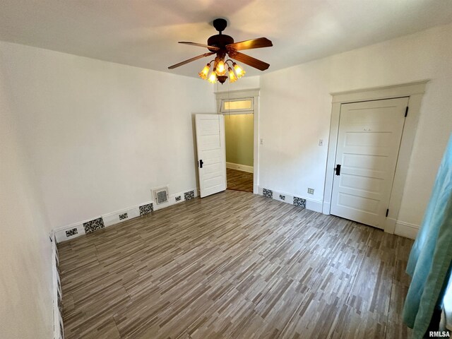 231 N Webster Ave, Jacksonville, IL 62650 - spare room featuring wood finished floors and a ceiling fan