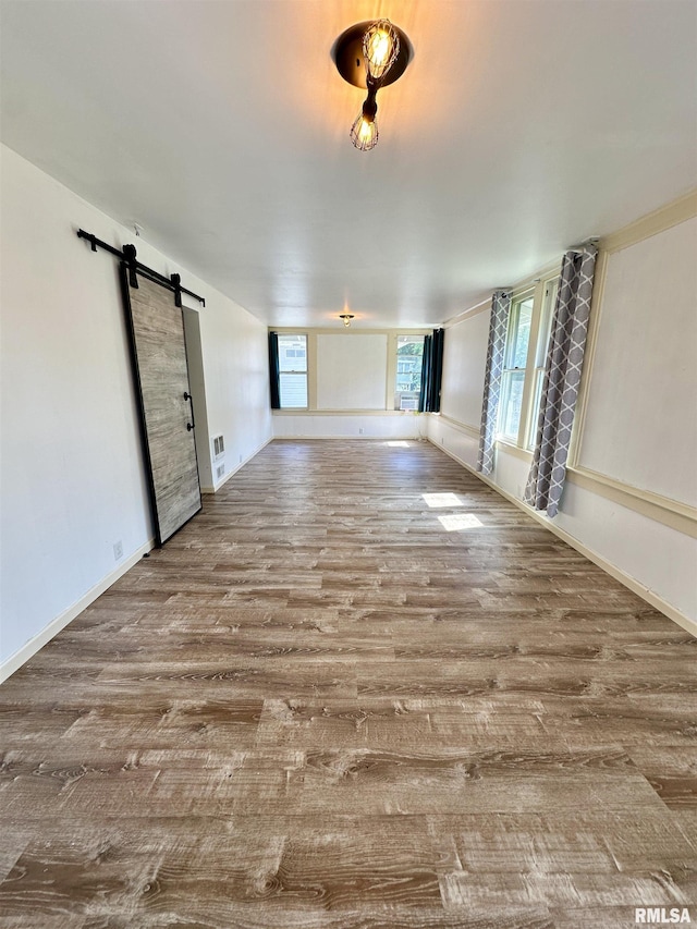 231 N Webster Ave, Jacksonville, IL 62650 - unfurnished room with wood finished floors and a barn door