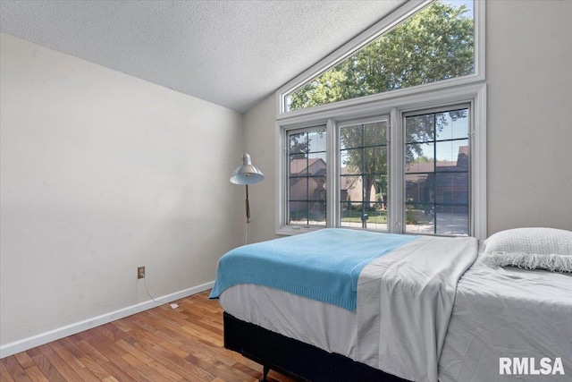 1009 Rickard Ct, Springfield, IL 62704 - bedroom with vaulted ceiling, wood finished floors, and a textured ceiling