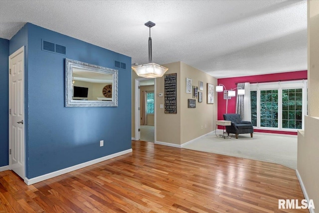 1009 Rickard Ct, Springfield, IL 62704 - unfurnished dining area featuring wood finished floors and a textured ceiling