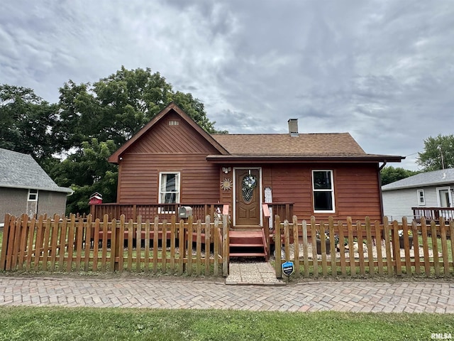 778 E Grove St, Galesburg, IL 61401 - rustic home featuring a fenced front yard, a chimney, and a deck
