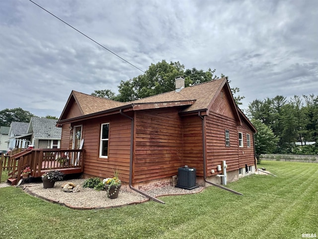 778 E Grove St, Galesburg, IL 61401 - view of side of home featuring a chimney, a yard, a shingled roof, and a deck