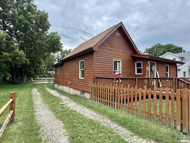 778 E Grove St, Galesburg, IL 61401 - view of home's exterior with driveway, a deck, and a lawn