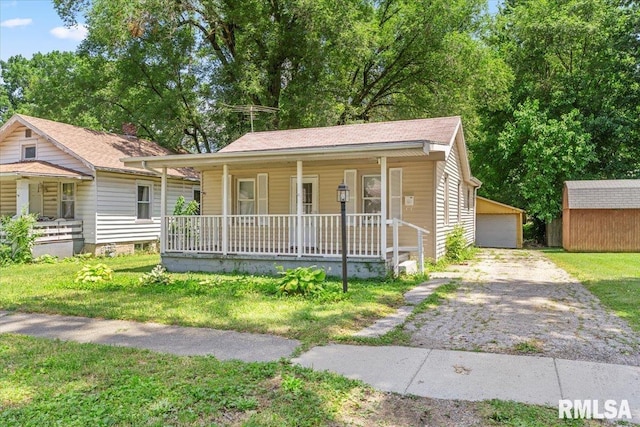 1310 Ledlie Ave, Springfield, IL 62702 - view of front of house with a porch, an outbuilding, and a front yard