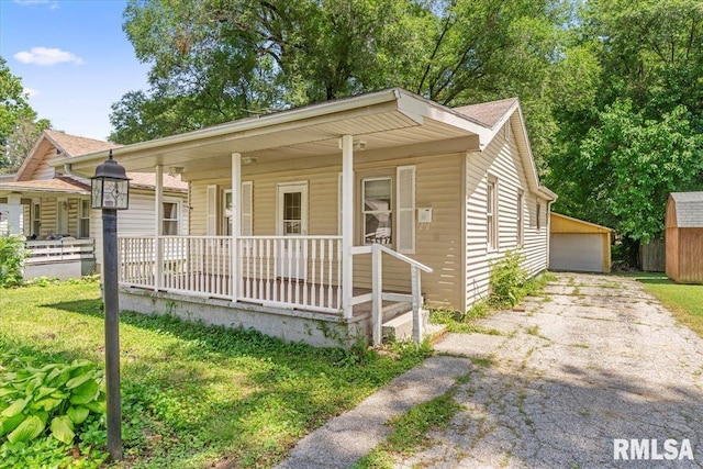 1310 Ledlie Ave, Springfield, IL 62702 - bungalow-style home with a porch, an outdoor structure, and a garage