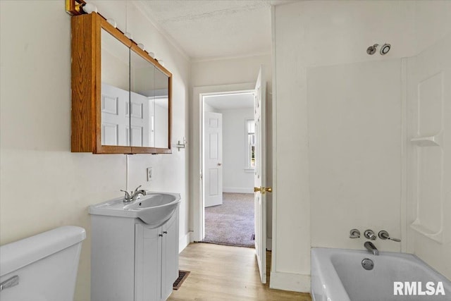 1310 Ledlie Ave, Springfield, IL 62702 - bathroom featuring vanity, wood finished floors, a textured ceiling, ornamental molding, and shower / washtub combination