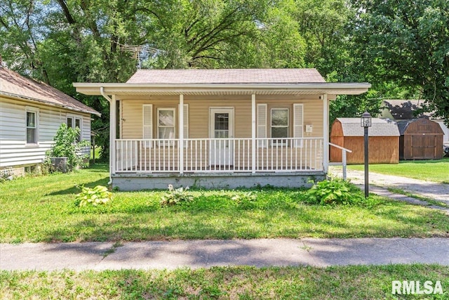 1310 Ledlie Ave, Springfield, IL 62702 - bungalow-style house with covered porch, a storage unit, and a front lawn
