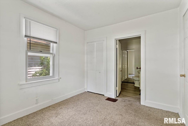 1310 Ledlie Ave, Springfield, IL 62702 - unfurnished bedroom featuring light colored carpet, ensuite bath, and a closet