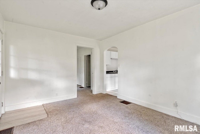 1310 Ledlie Ave, Springfield, IL 62702 - empty room with light colored carpet and arched walkways