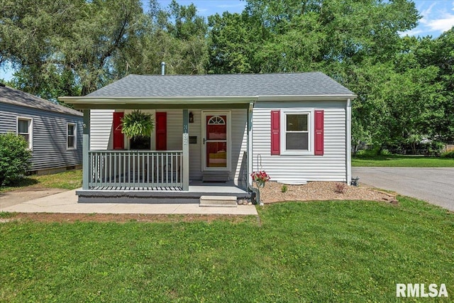 3132 S 4th St, Springfield, IL 62703 - view of front of house with covered porch, a front yard, and a shingled roof