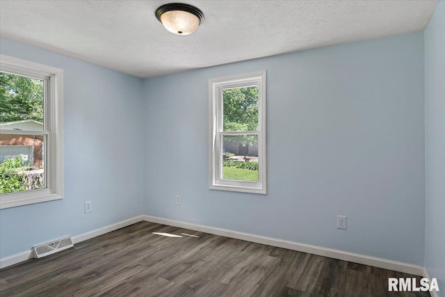 3132 S 4th St, Springfield, IL 62703 - unfurnished room featuring dark wood-style flooring, healthy amount of natural light, and a textured ceiling