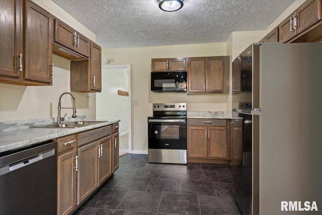 3132 S 4th St, Springfield, IL 62703 - kitchen with stainless steel appliances, a textured ceiling, and light stone countertops