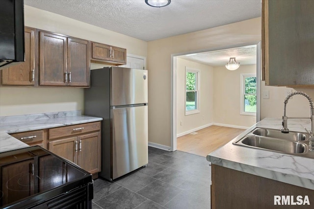 3132 S 4th St, Springfield, IL 62703 - kitchen with freestanding refrigerator, black electric range, and a textured ceiling
