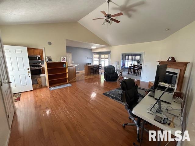 4424 Venetian Dr, Springfield, IL 62703 - office space with a ceiling fan, light wood-type flooring, high vaulted ceiling, and a glass covered fireplace
