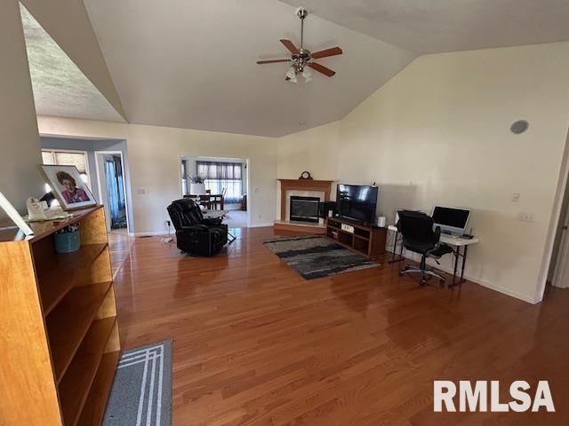 4424 Venetian Dr, Springfield, IL 62703 - living area featuring lofted ceiling, ceiling fan, a glass covered fireplace, wood finished floors, and a desk