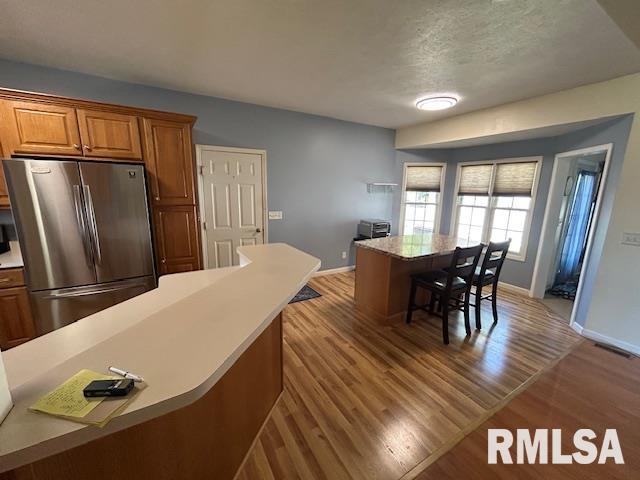 4424 Venetian Dr, Springfield, IL 62703 - dining room featuring light wood-style floors and a textured ceiling