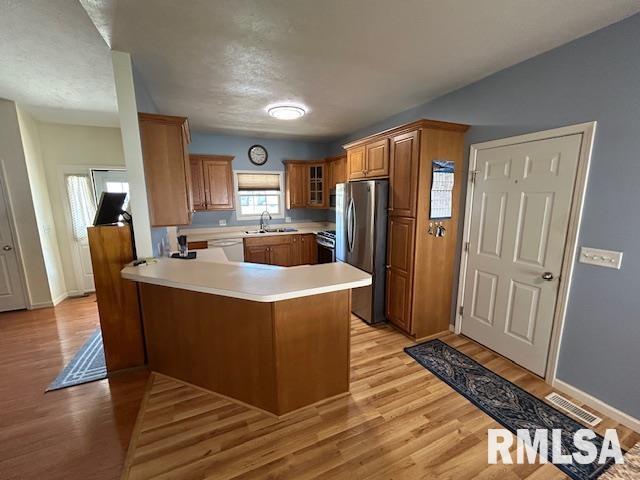 4424 Venetian Dr, Springfield, IL 62703 - kitchen featuring freestanding refrigerator, a peninsula, light wood finished floors, and white dishwasher