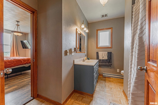 209 N 2nd St N, Easton, IL 62633 - ensuite bathroom featuring a baseboard radiator, a textured wall, and vanity