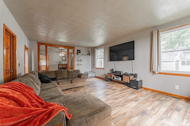 209 N 2nd St N, Easton, IL 62633 - living room featuring wood finished floors, plenty of natural light, and ceiling fan