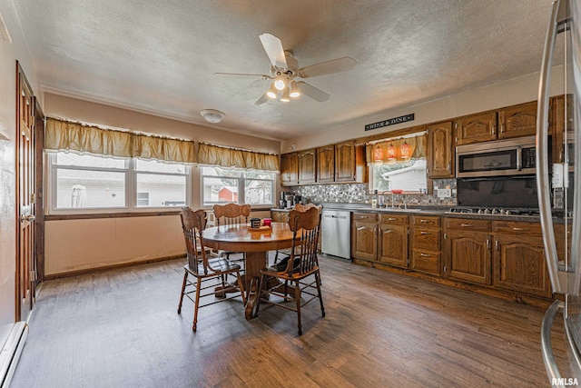 209 N 2nd St N, Easton, IL 62633 - dining space with baseboard heating, dark wood-type flooring, ceiling fan, and a textured ceiling
