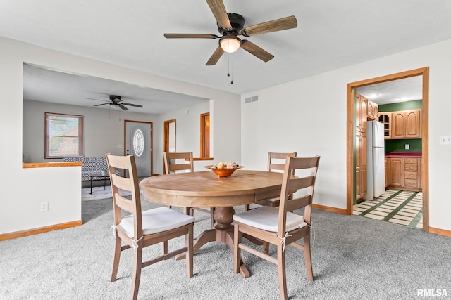 321 N 5th St, Petersburg, IL 62675 - dining area featuring ceiling fan and light colored carpet