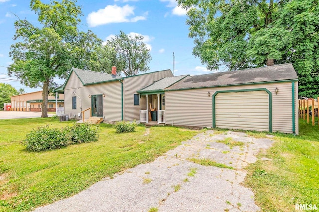 321 N 5th St, Petersburg, IL 62675 - view of front of house featuring driveway, a front lawn, a garage, and a chimney
