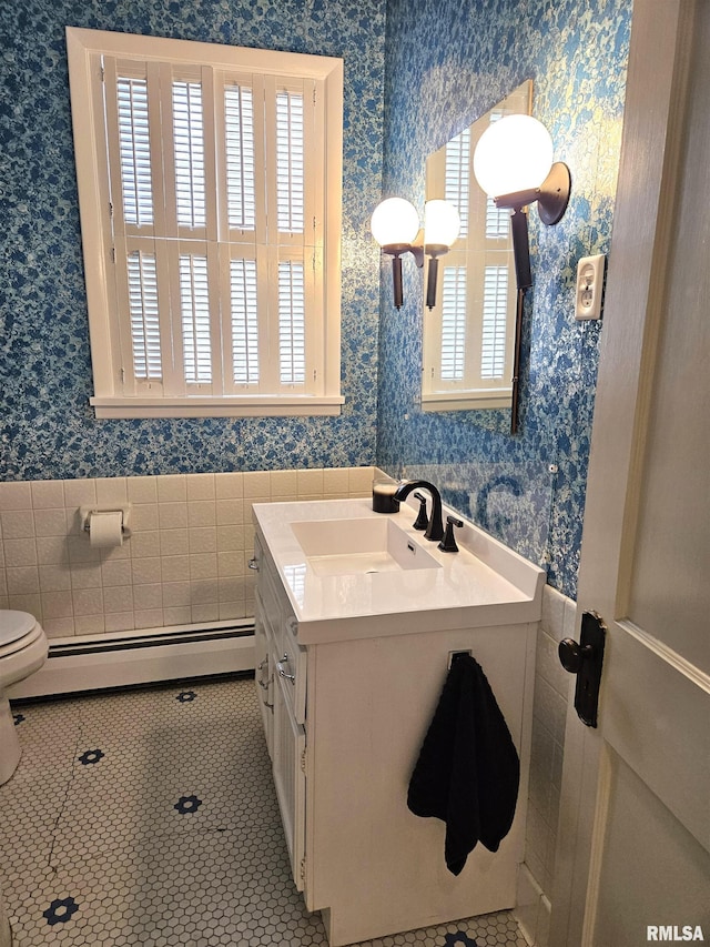1155 N Cherry St, Galesburg, IL 61401 - bathroom with a baseboard radiator, vanity, wallpapered walls, plenty of natural light, and wainscoting
