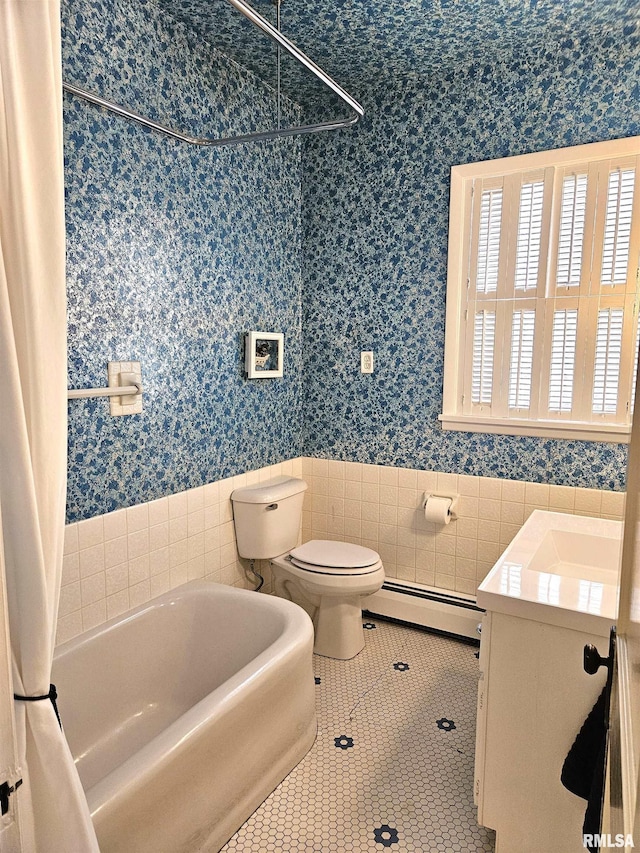 1155 N Cherry St, Galesburg, IL 61401 - bathroom with a baseboard radiator, wallpapered walls, vanity, tile patterned floors, and tile walls