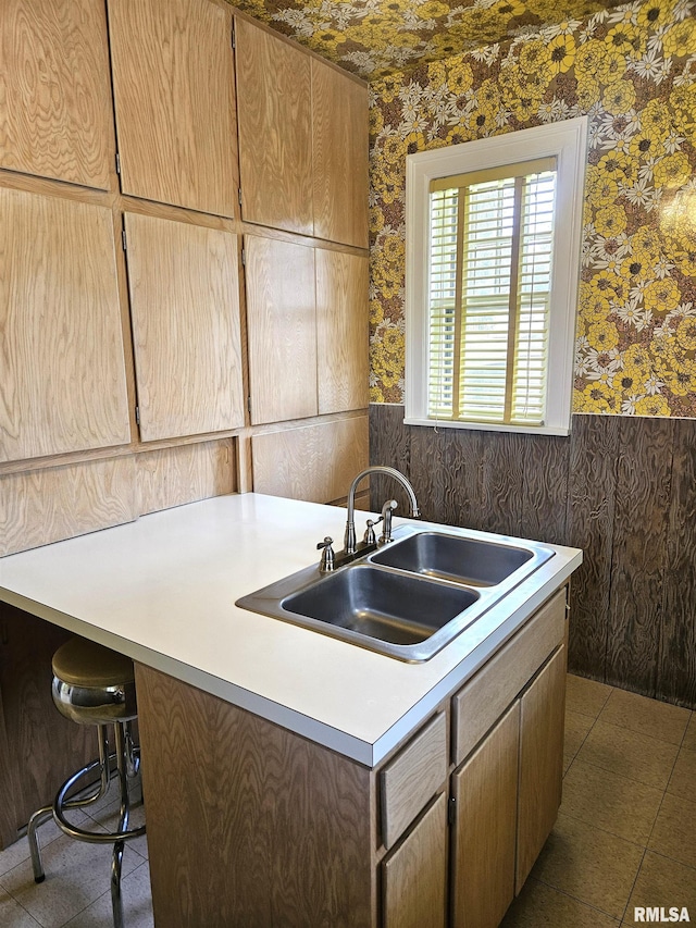 1155 N Cherry St, Galesburg, IL 61401 - kitchen with wallpapered walls, light countertops, and a breakfast bar