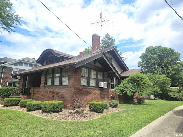 1155 N Cherry St, Galesburg, IL 61401 - view of home's exterior featuring brick siding, a lawn, a chimney, cooling unit, and a shingled roof