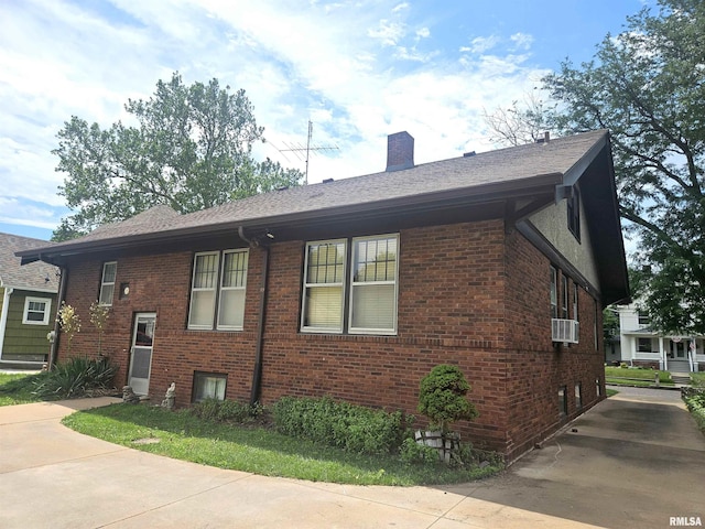1155 N Cherry St, Galesburg, IL 61401 - view of property exterior with brick siding, a chimney, a shingled roof, and cooling unit