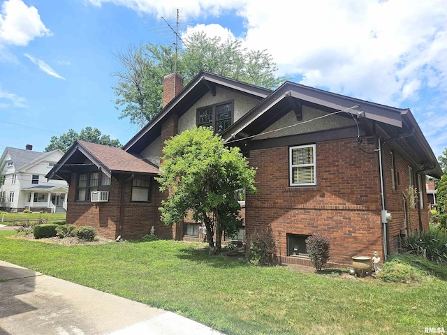 1155 N Cherry St, Galesburg, IL 61401 - view of front facade featuring brick siding, a front lawn, a chimney, and cooling unit