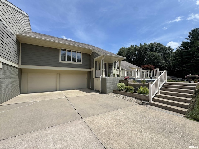 6 Ottawa Trl, Galesburg, IL 61401 - view of front of house featuring driveway, a garage, covered porch, and a shingled roof