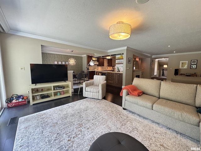 6 Ottawa Trl, Galesburg, IL 61401 - living room featuring crown molding, dark wood-style flooring, and a textured ceiling