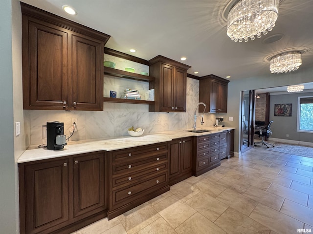 6 Ottawa Trl, Galesburg, IL 61401 - kitchen featuring a chandelier, dark brown cabinets, decorative backsplash, light stone counters, and recessed lighting