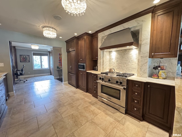 6 Ottawa Trl, Galesburg, IL 61401 - kitchen with wall chimney range hood, high end appliances, a chandelier, tasteful backsplash, and recessed lighting