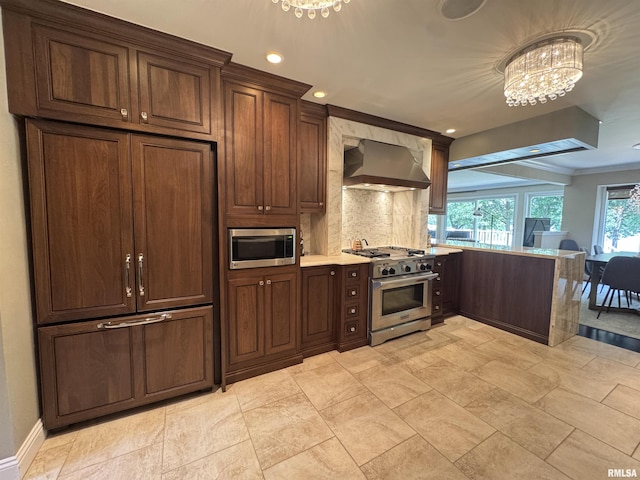 6 Ottawa Trl, Galesburg, IL 61401 - kitchen featuring high end appliances, range hood, a chandelier, a peninsula, and backsplash