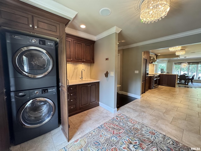 6 Ottawa Trl, Galesburg, IL 61401 - washroom featuring estacked washer and dryer, a chandelier, crown molding, and recessed lighting
