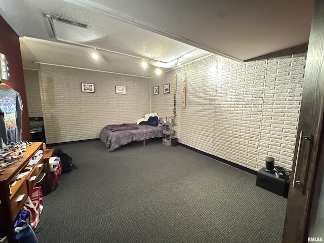 6 Ottawa Trl, Galesburg, IL 61401 - carpeted bedroom with attic access, rail lighting, and brick wall