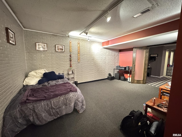 6 Ottawa Trl, Galesburg, IL 61401 - bedroom featuring brick wall, carpet flooring, rail lighting, and crown molding