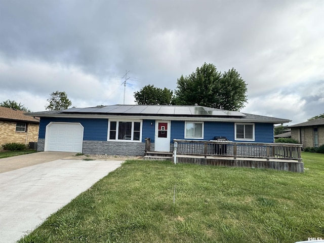 1275 Sunview Dr, Canton, IL 61520 - ranch-style house featuring a front yard, a garage, roof mounted solar panels, and stone siding