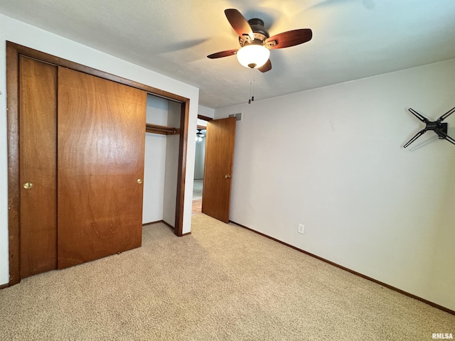 1275 Sunview Dr, Canton, IL 61520 - unfurnished bedroom with a closet, light colored carpet, and ceiling fan